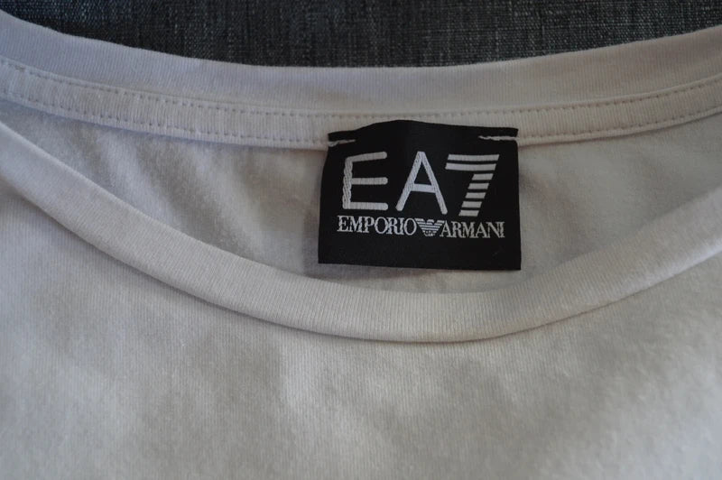 EA7 Emporio Armani – Damen Cropped T-Shirt in Weiß mit Ärmel-Prints – Gr. L (Stark getragen / Defekt- & Bastlerpreis)